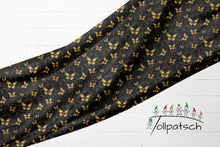 Laden Sie das Bild in den Galerie-Viewer, Golden Glow Baumwolljersey mit goldenen Schmetterlingen | Eleganter Jersey Stoff Schwarz Gold
